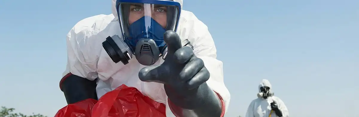 sewage clean up technician wearing protective gear handling biohazard materials in West Palm Beach, FL